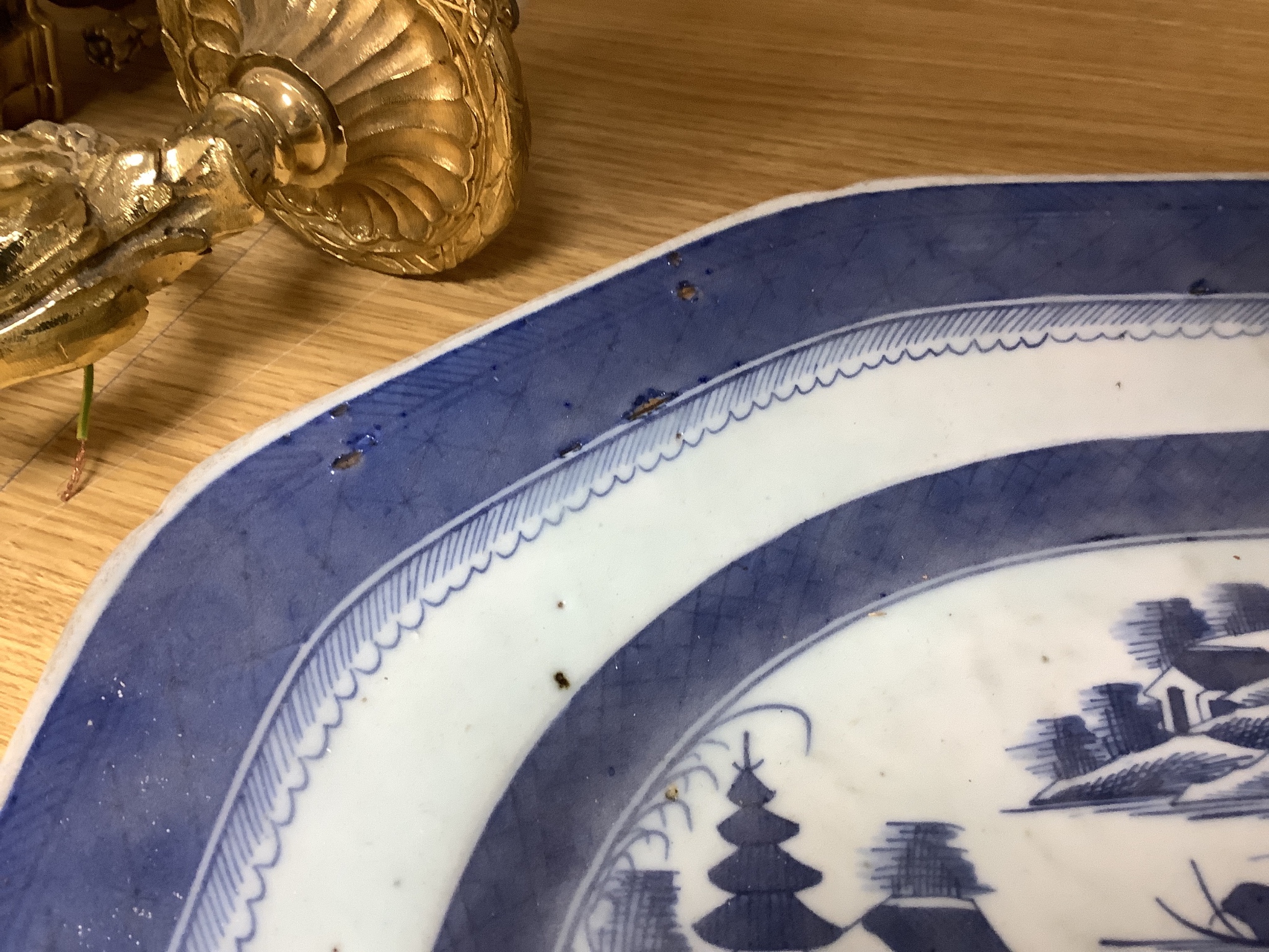 A 19th century Chinese export blue and white plate, decorated with pagoda scenes, length 42cm